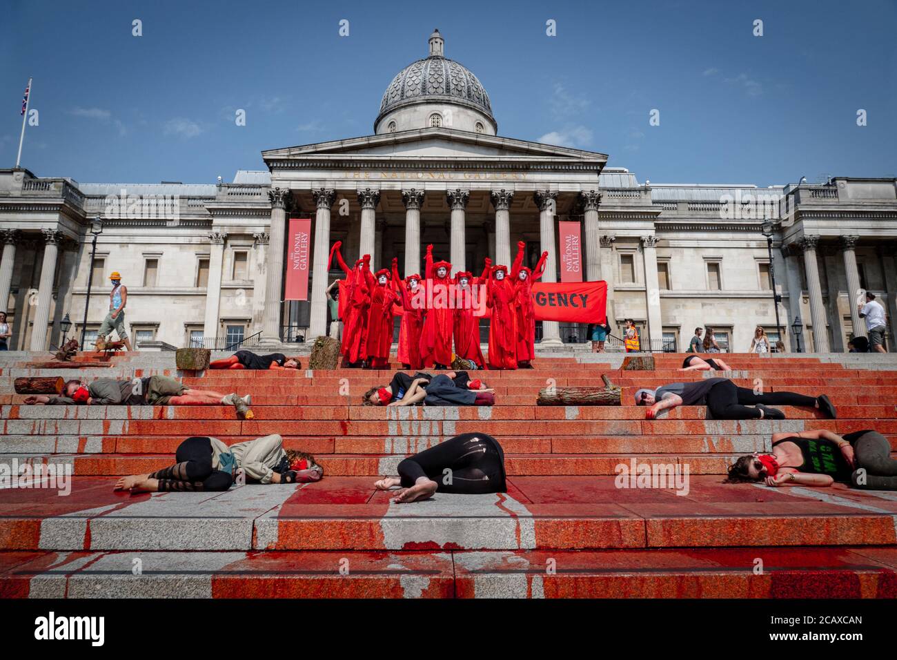 London, United Kingdom, Aug 09 2020: Extinction Rebellion Activists cover of `fake blood the stairs of trafalgar sq for International Day of the World Stock Photo